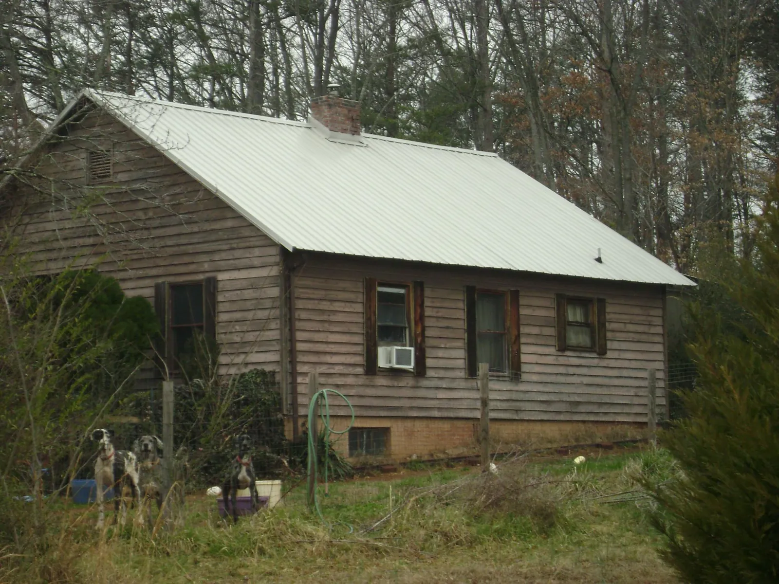 White metal roof on an old wood sided farmhouse, from a Metal Roof Installation job in Crestwood